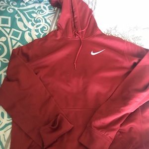 A red Nike hoodie with a white check